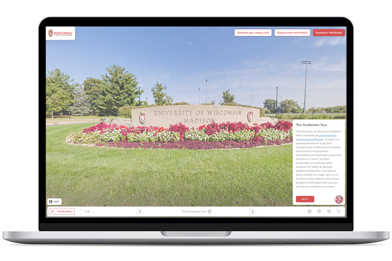 Laptop displaying a University of Wisconsin–Madison sign surrounded by flowers within a virtual tour application.