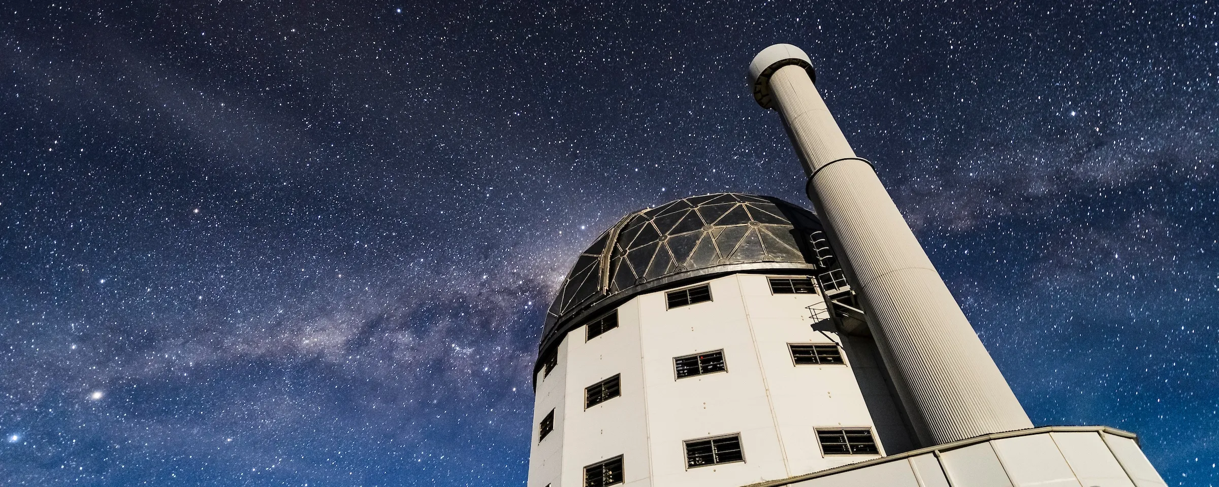 The Southern African Large Telescope under a starry sky with a visible Milky Way.